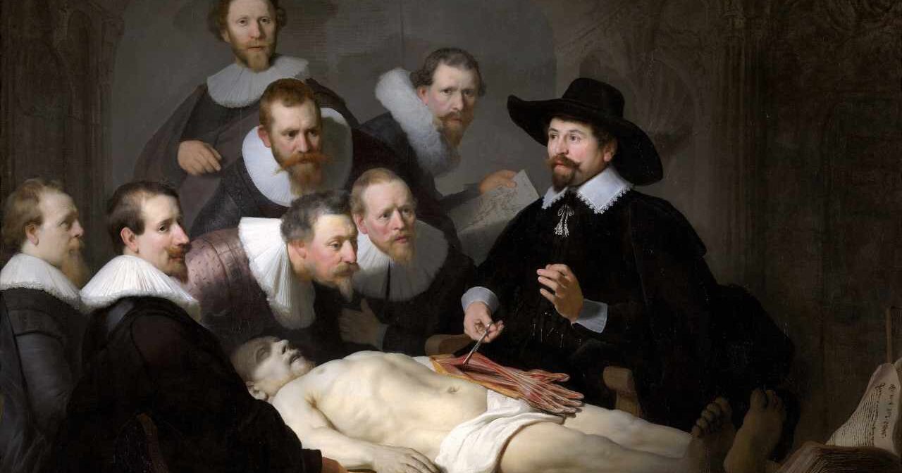 anatomists satnding around pointing at a cadaver